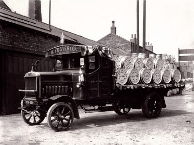 Black and white photograph of H Foster wagon with barrels on the back.