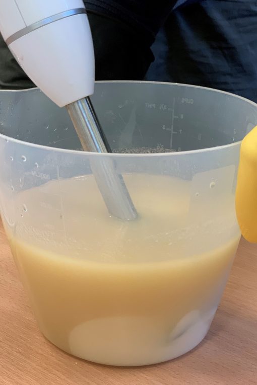 Clear plastic jug filled with cream liquid soap.